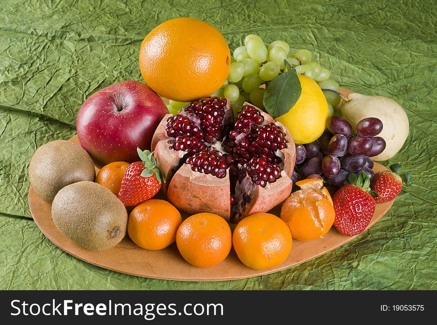 Fresh fruit still life with pomegranate, tangerine, lemon, orange, grape and strawberries