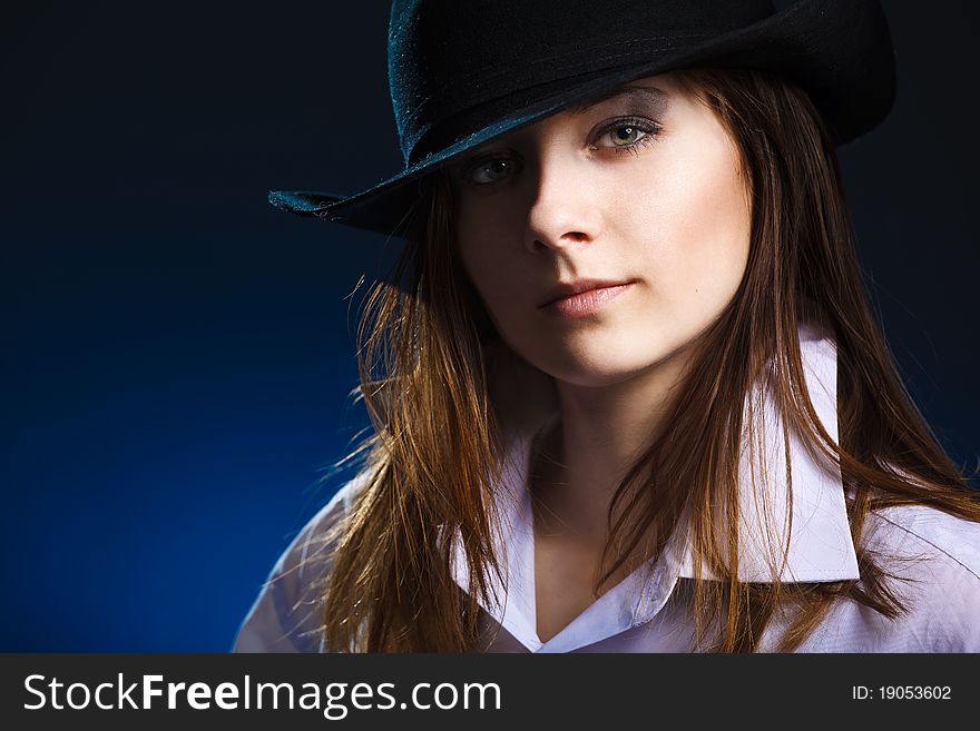 Young woman with hat and black eyeshadow