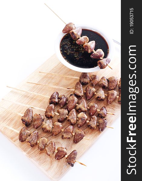 Grilled chicken hearts on skewers with soy sauce.