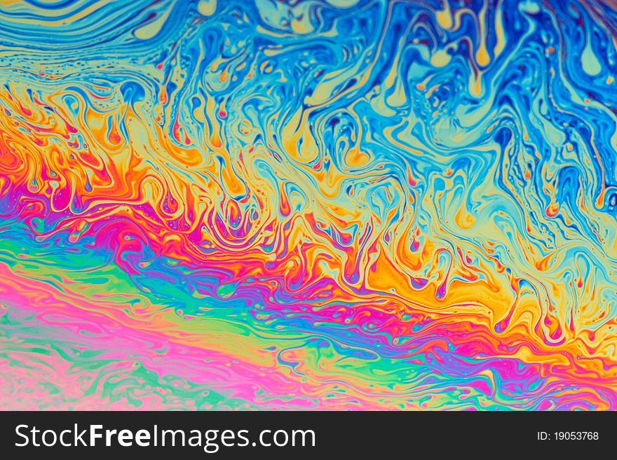 Colourful iridescent fluid abstract background in rainbow colours