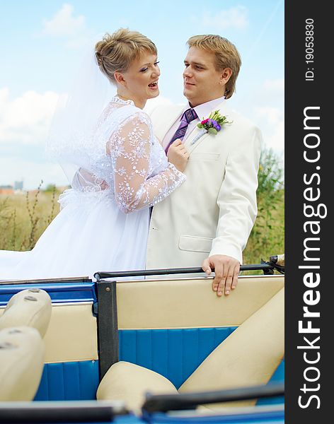 Bride and groom fooling with funny expressions outside