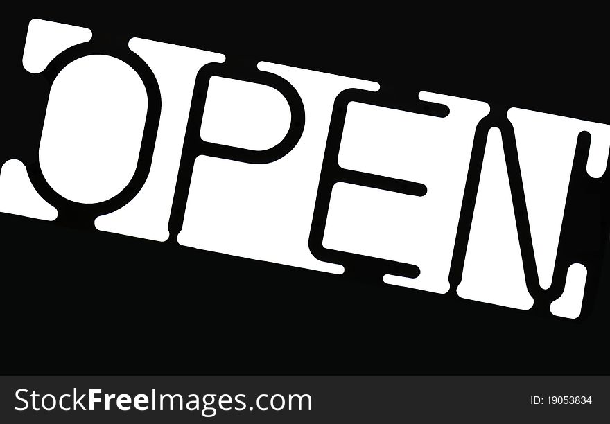 An isolated slanted black and white open sign.