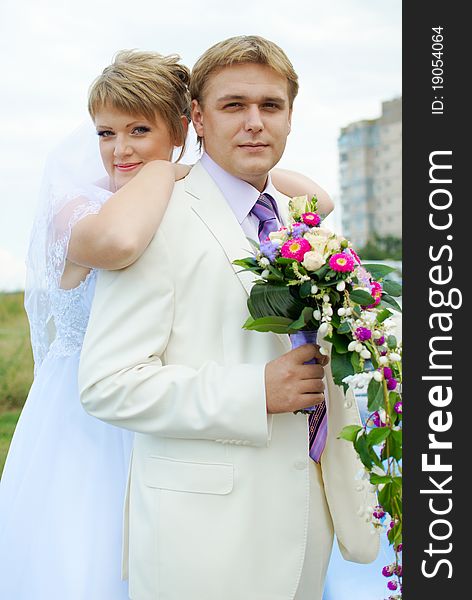 Bride and groom hugging outdoor