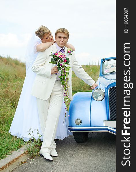 Bride and groom hugging outdoor