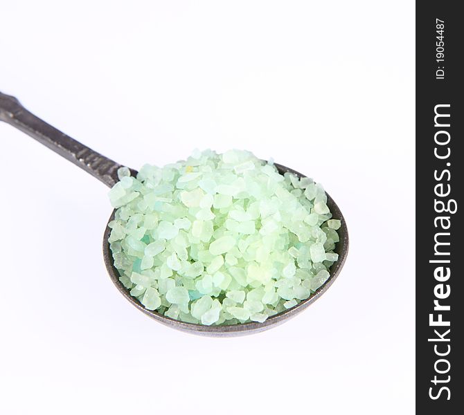 Green spa salt on an antique spoon