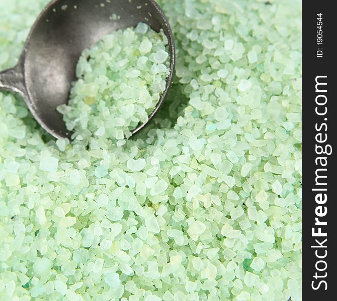 Green spa salt, some on an antique spoon