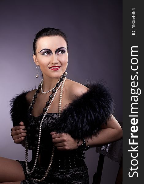 Woman smile in fur boa and pearl beads