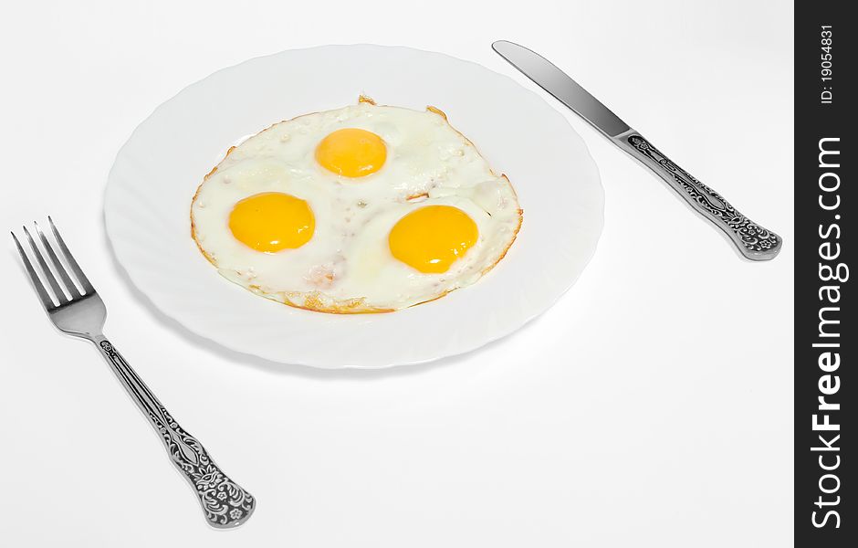 Fried Eggs  on a plate isolated on white