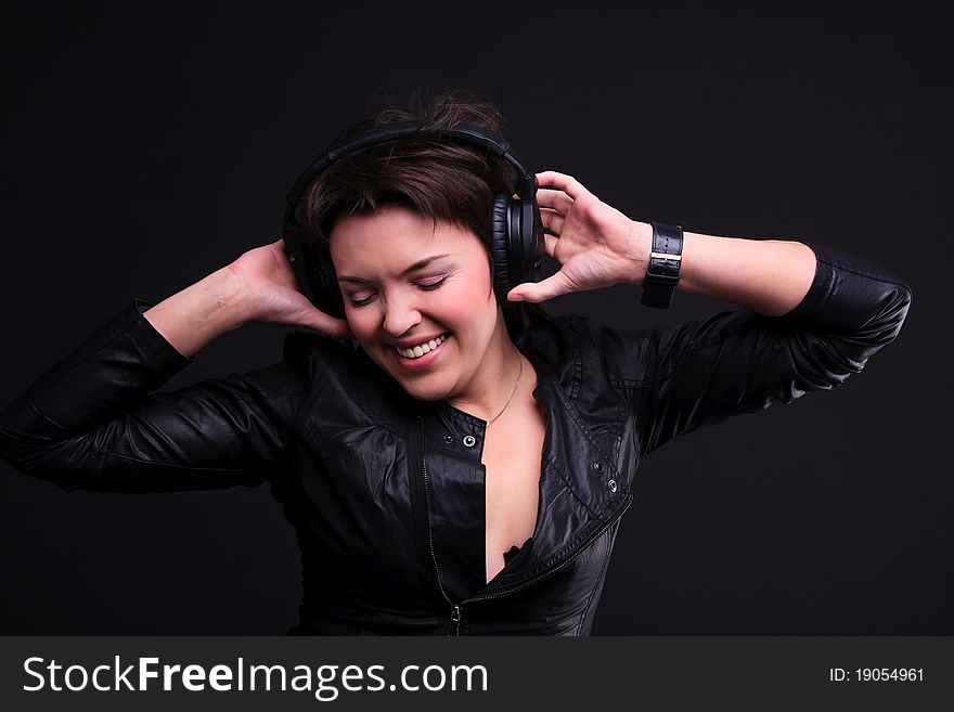 The beautiful young brunette girl in headphones. The beautiful young brunette girl in headphones