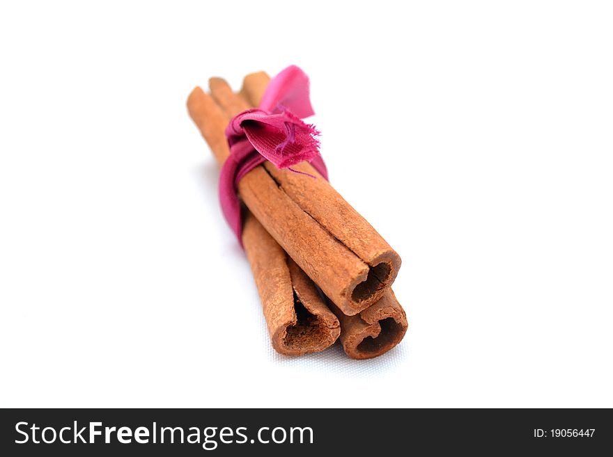 Photo of a sheaf of cinnamon on a white background