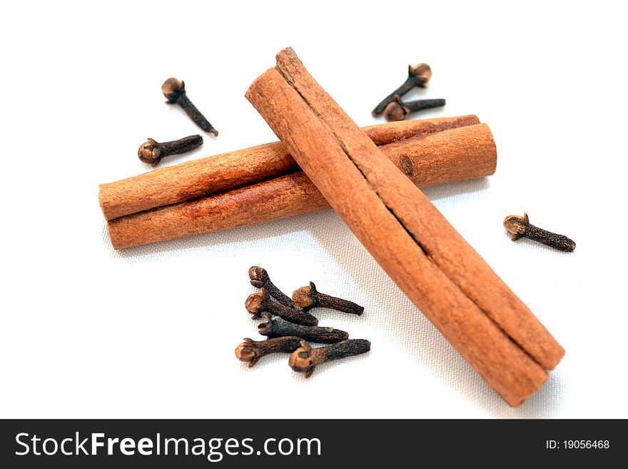 Photo of cinnamon and carnation on a white background