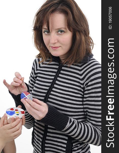 Woman painting easter eggs