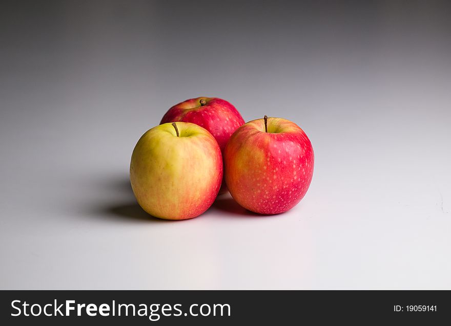 Three Apples on a gradient grey background
