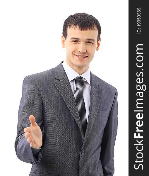 Portrait of a handsome young man in a business suit about to shake somebody's hand