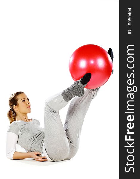 Girl exercising with a red ball, on a white background. Girl exercising with a red ball, on a white background