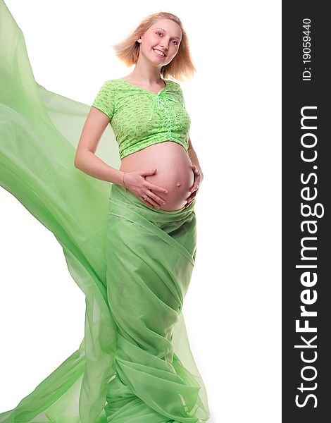 Beautiful young pregnant blonde woman with green transparent cloth in studio. Beautiful young pregnant blonde woman with green transparent cloth in studio