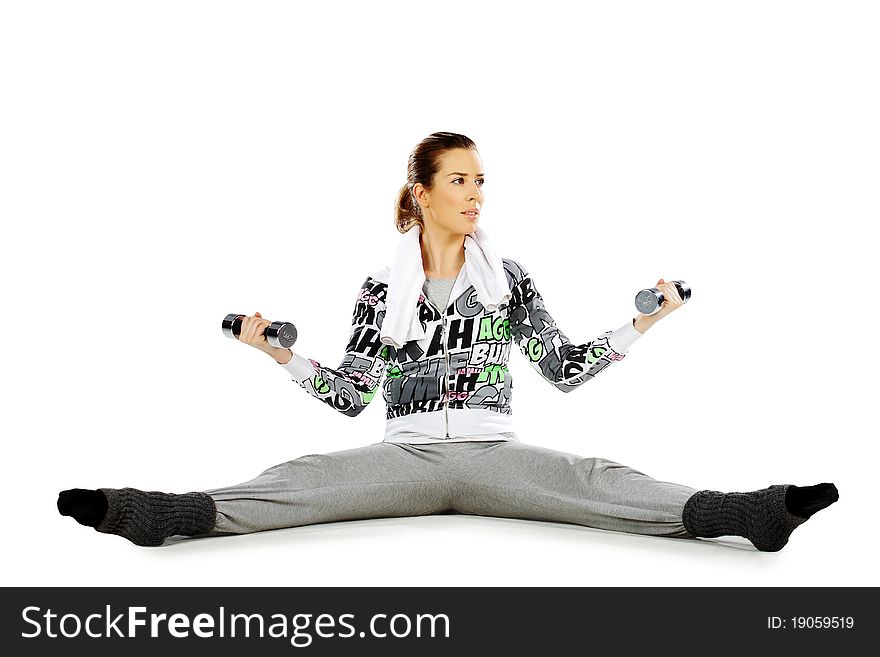 Girl sitting and exercising with weights, on a white background