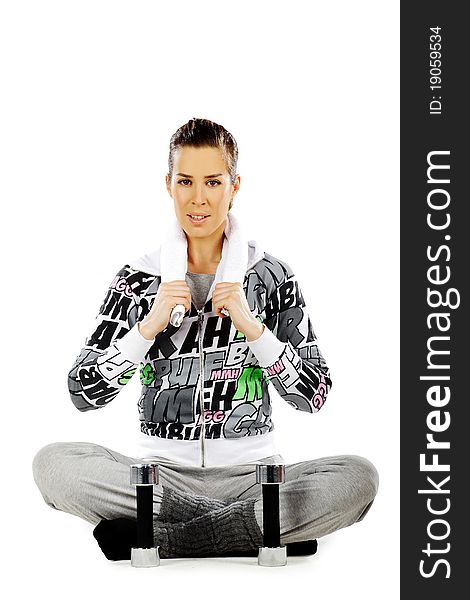 Girl sitting and relaxing after workout with weights, on a white background