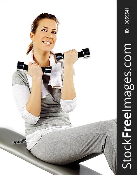 Girl exercising with weights, on a white background. Girl exercising with weights, on a white background