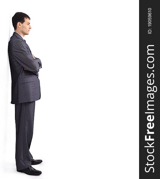 Cheerful young businessman leaning against wall. Cheerful young businessman leaning against wall