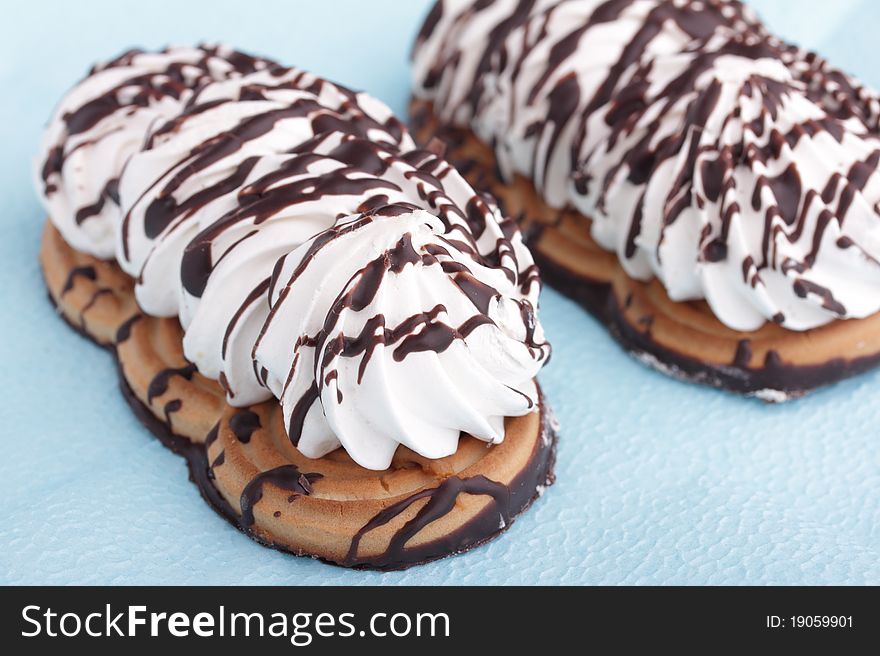 Cakes With  Chocolate Icing On Blue Background