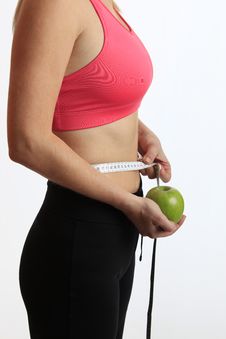 Woman With Green Apple And Measure Tape Stock Images