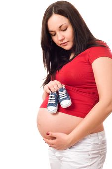 A Pregnant Woman Holding Baby Shoes Stock Images A Pregnant Woman Holding Baby Shoes Stock Images