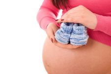 A Pregnant Woman Holding Baby Shoes Royalty Free Stock Photography A Pregnant Woman Holding Baby Shoes Royalty Free Stock Photography