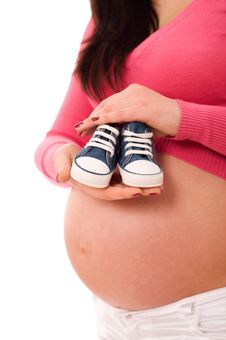 A Pregnant Woman Holding Baby Shoes Stock Photo A Pregnant Woman Holding Baby Shoes Stock Photo