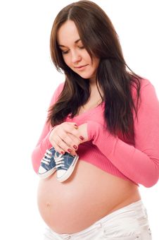 A Pregnant Woman Holding Baby Shoes Stock Photography A Pregnant Woman Holding Baby Shoes Stock Photography