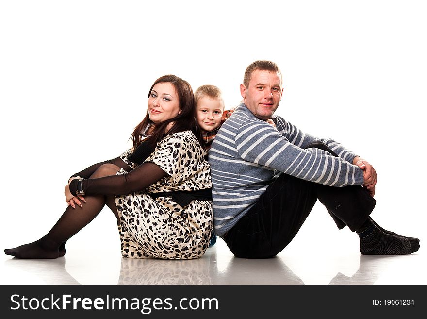 Portrait of a young happy smiling family isolated on white