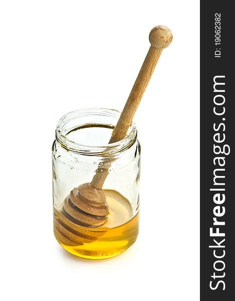 Honey in glass jar isolated