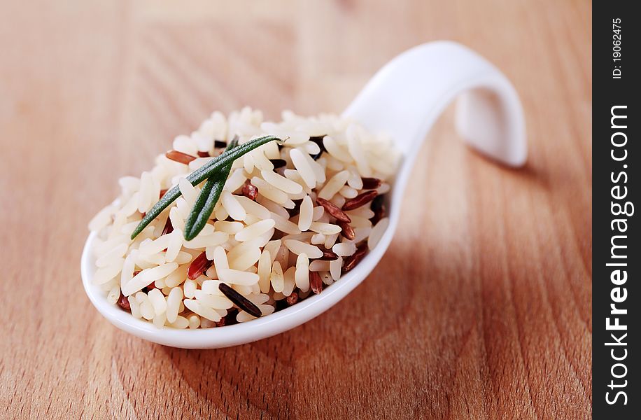 Mixed rice on a ceramic spoon - detail