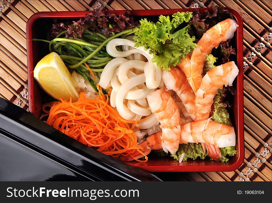 traditional Japanese cuisine in a box with seafood and vegetables