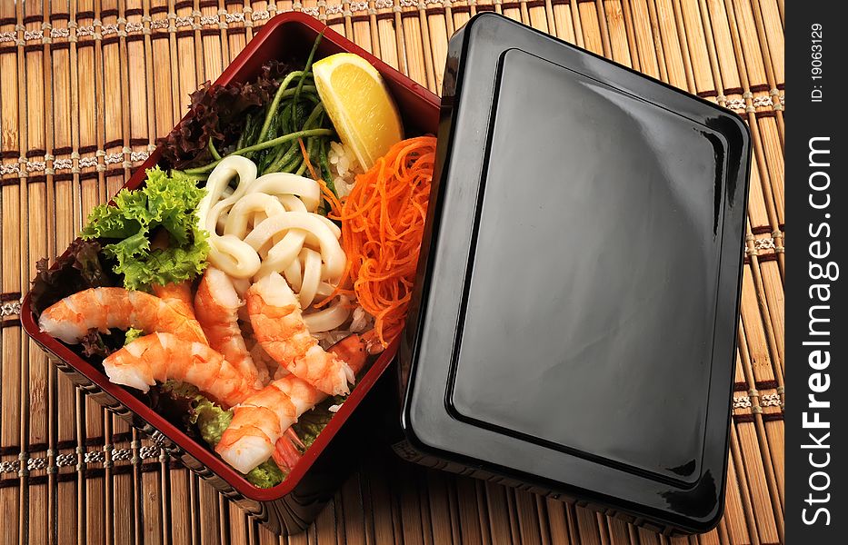 Traditional Japanese cuisine in a box with seafood and vegetables