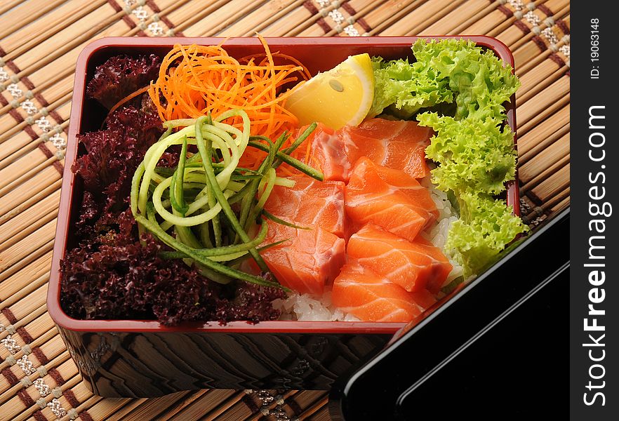 Japanese cuisine, fresh fish and vegetables in a box