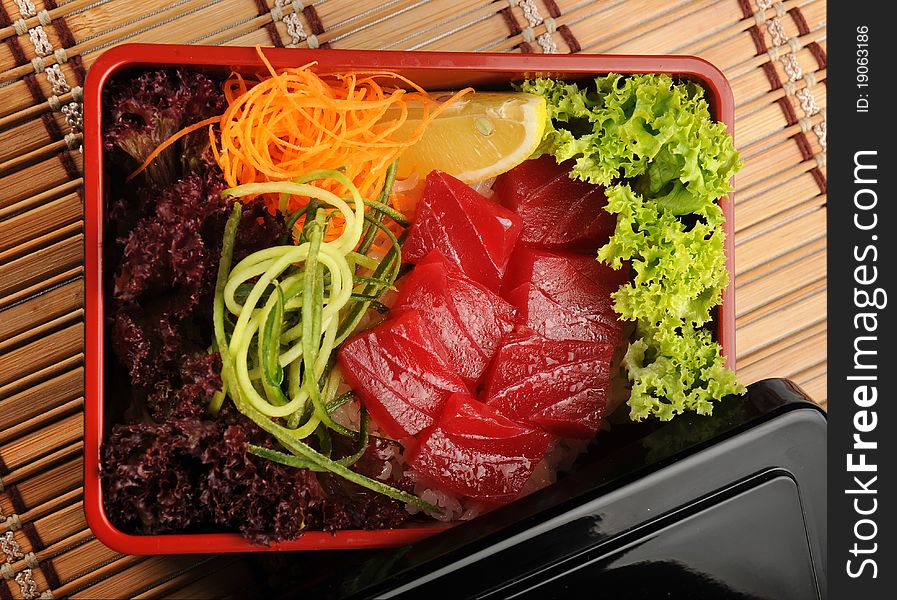 Japanese cuisine, fresh fish and vegetables in a box