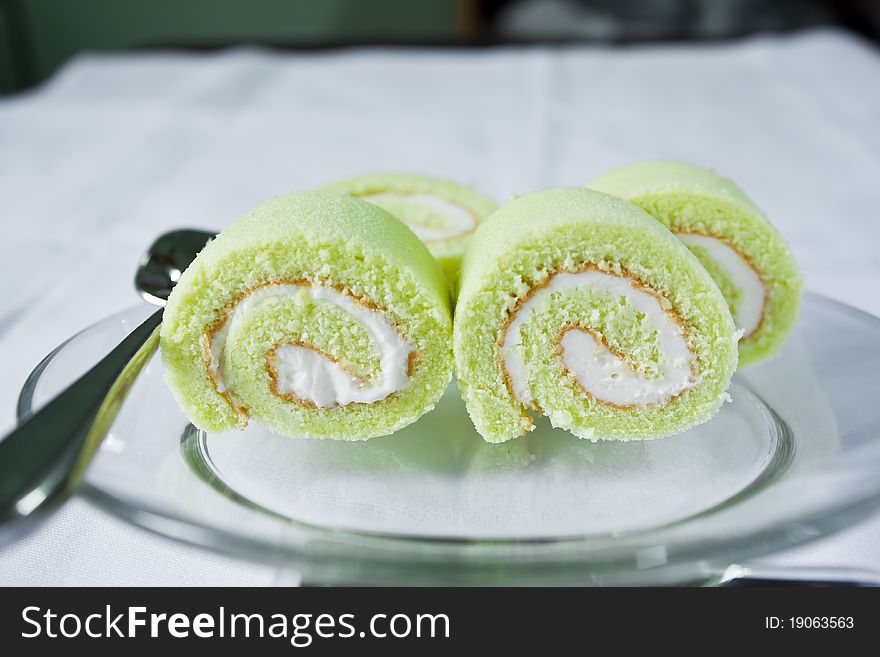 Cream cake with green paste on the plate. Cream cake with green paste on the plate.