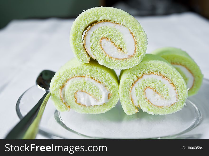 Cream cake with green paste on the plate. Cream cake with green paste on the plate.