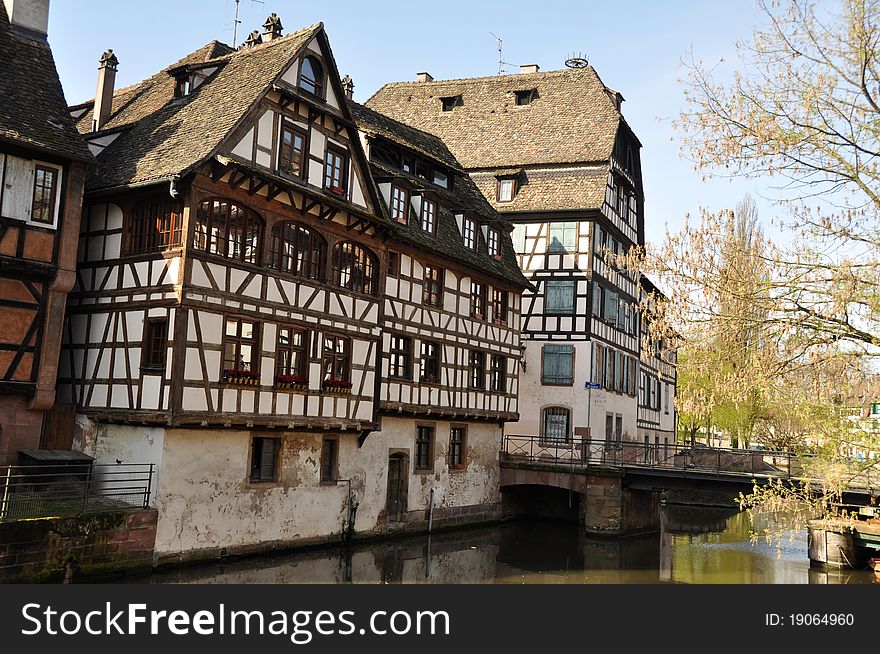 Half-timbered medieval residential houses on the banks of Ille river in Petit France neighbourhood in Strasbbourg, Alsace, France. Half-timbered medieval residential houses on the banks of Ille river in Petit France neighbourhood in Strasbbourg, Alsace, France