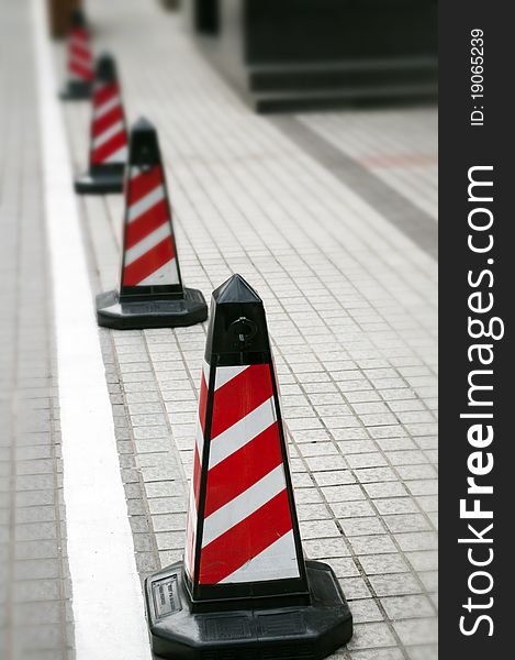 A road cone with reflective bands. A road cone with reflective bands