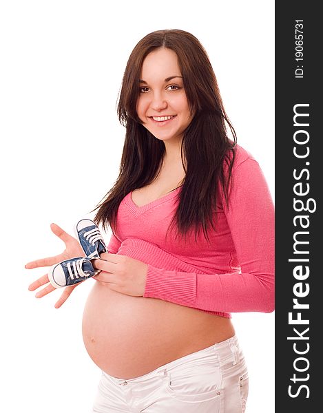 A Pregnant Woman Holding Baby Shoes