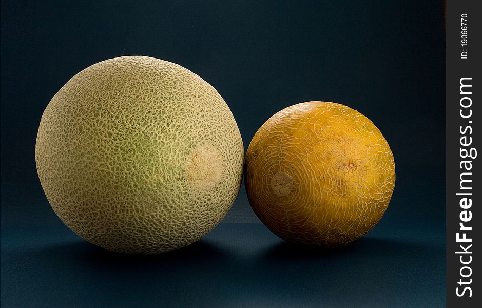 Two Cantaloupes - green and yellow. Two Cantaloupes - green and yellow