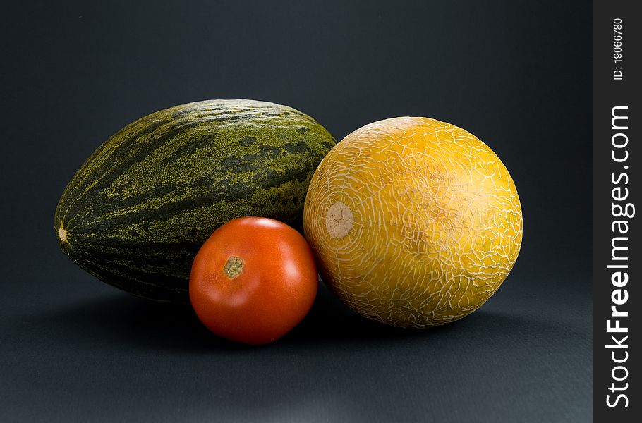 A couple of fruits and vegetables - melon, cantaloupe, tomato. A couple of fruits and vegetables - melon, cantaloupe, tomato