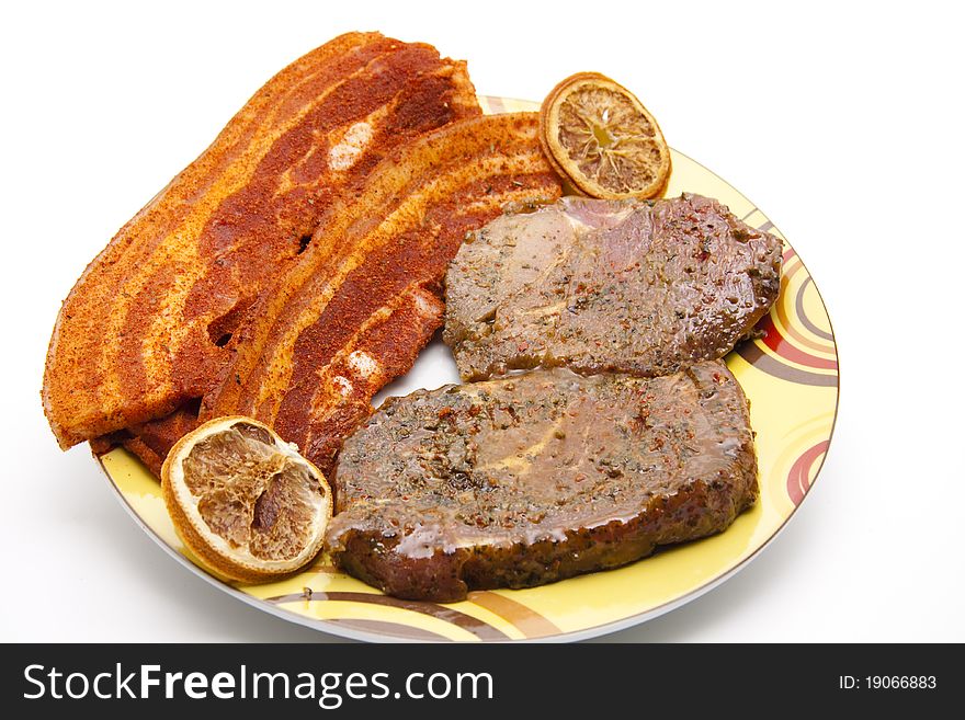 Seasoned steak and on ceramics plate. Seasoned steak and on ceramics plate