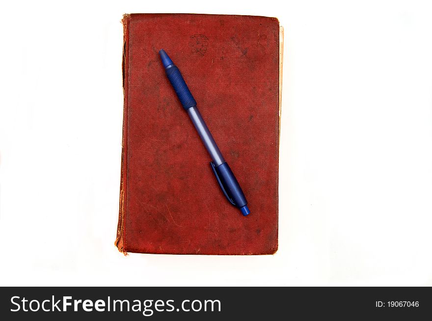 Old book and pen isolated on a white background