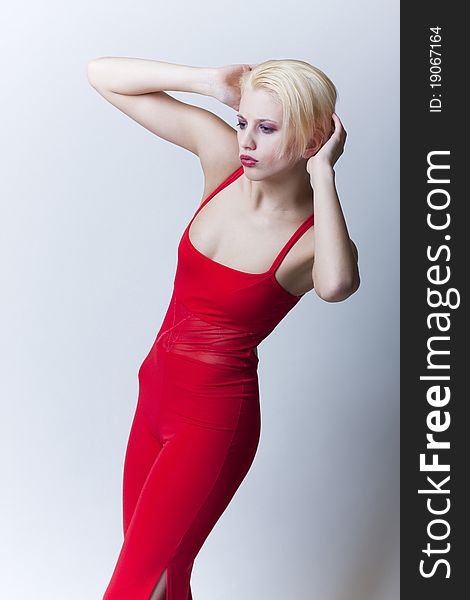 Beautiful sensual blond girl in red clothes