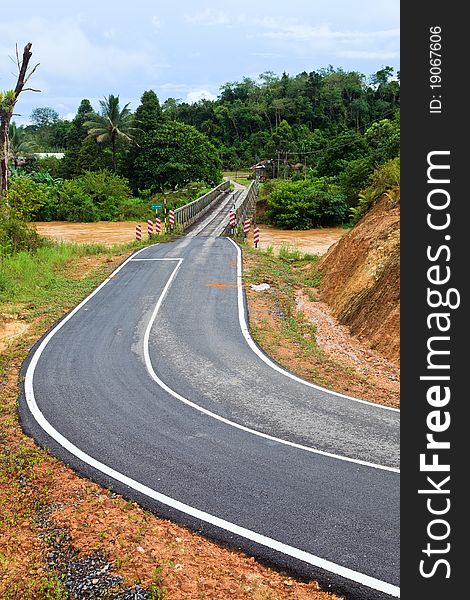 Road with bridge over a brown river