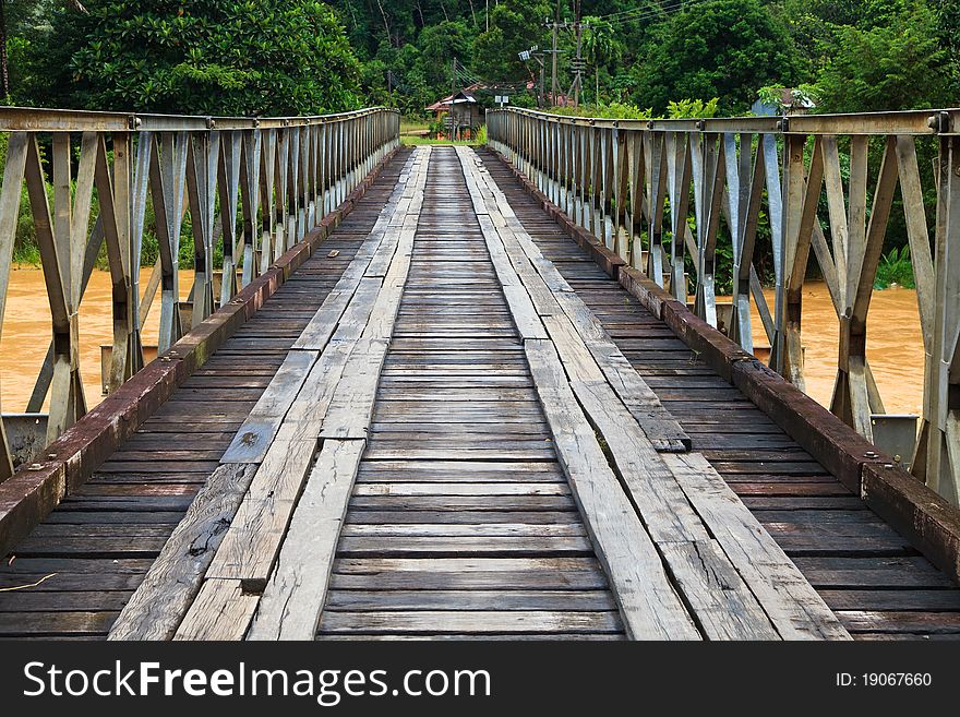 Old bridge over a brown river in the amazon