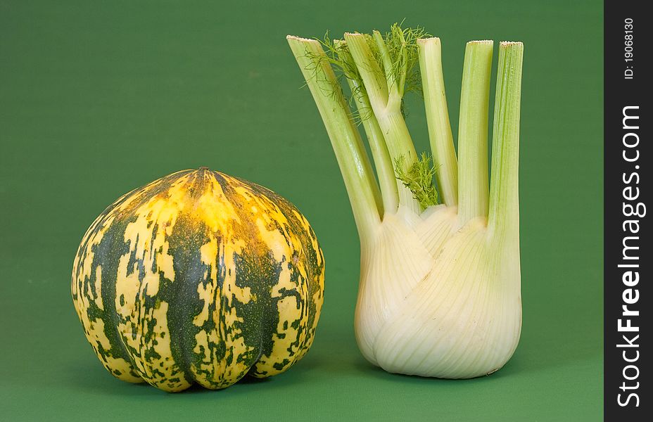 Fennel and pumpkin foreground on a green background